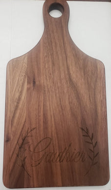 Paddle shaped cutting board made from Walnut wood, 13.5 inches tall by 7 inches wide
